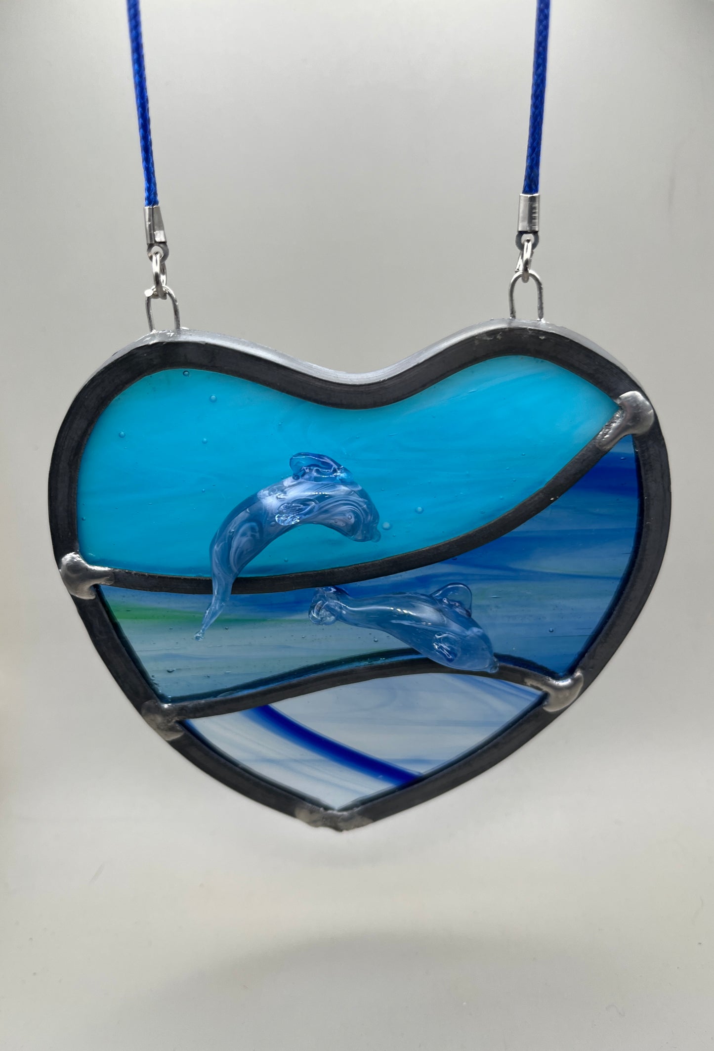 Dancing dolphins glass heart