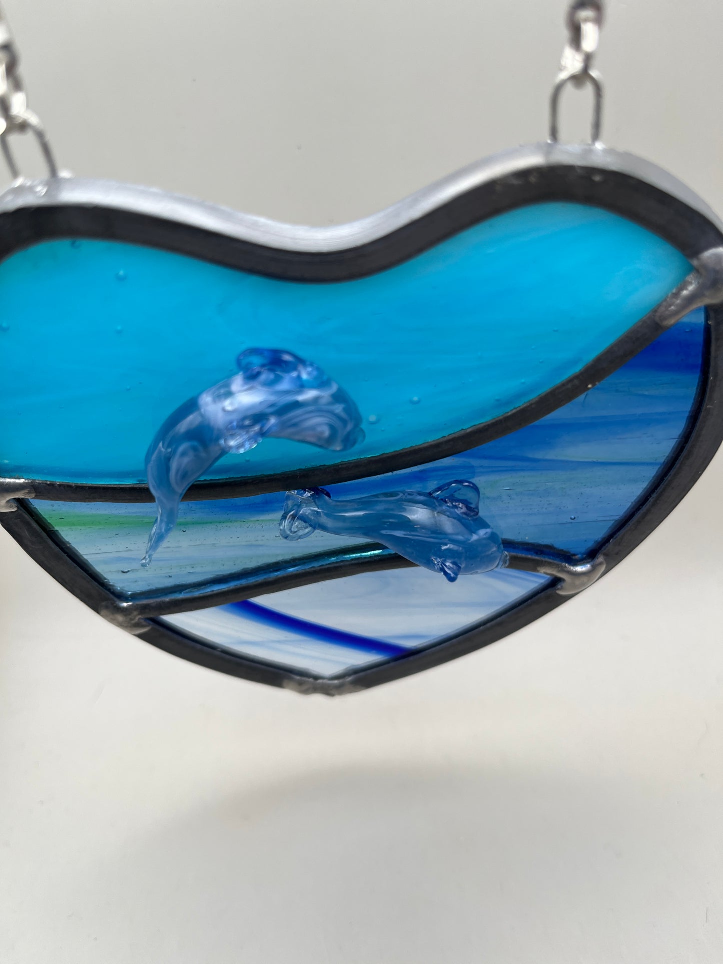 Dancing dolphins glass heart